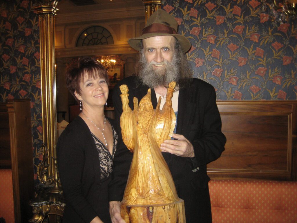 Barney Barnwell holding his Wood Carving Art